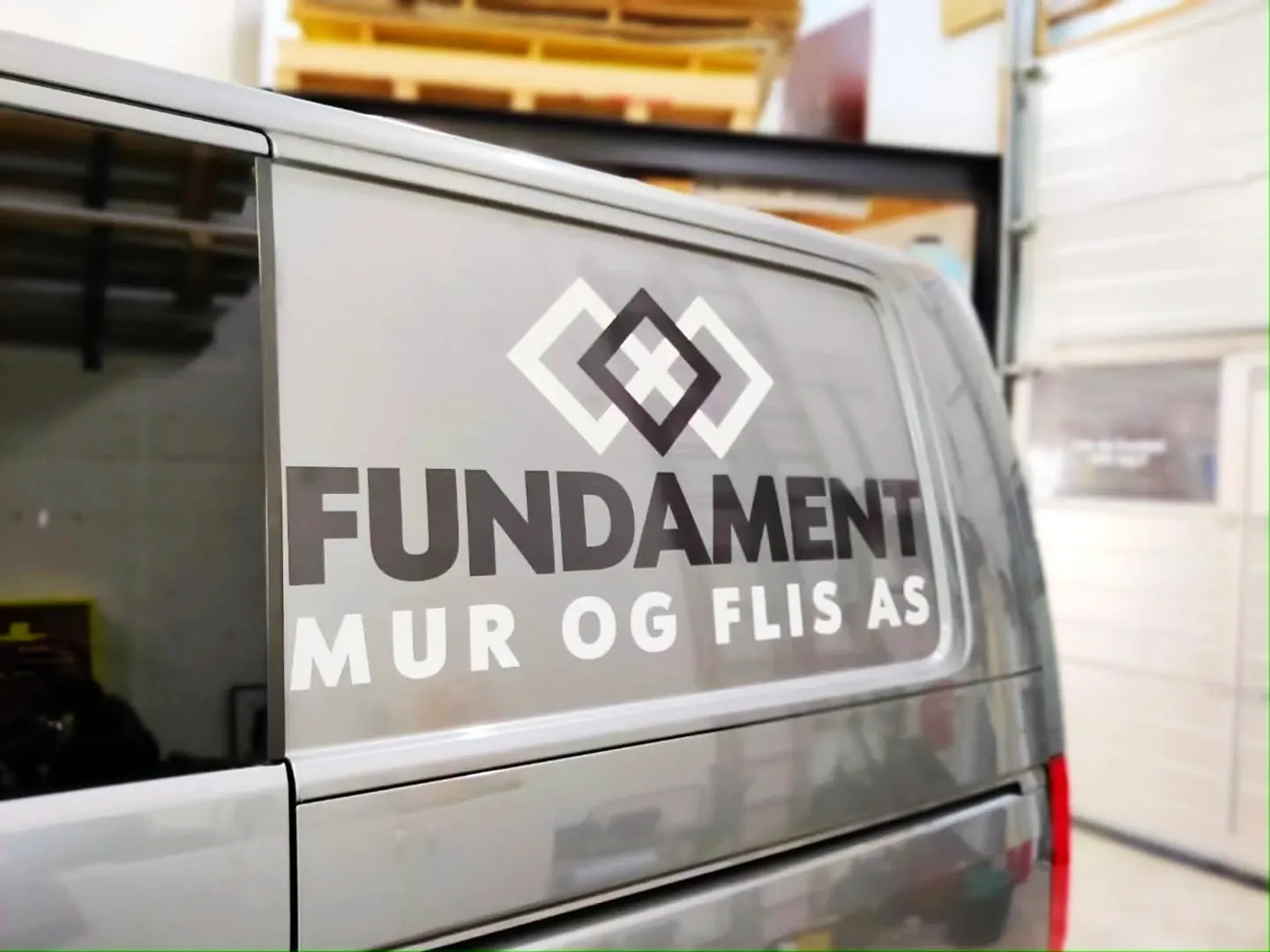 Fundament Mur og Flis-logo på sidevinduet av VW T6